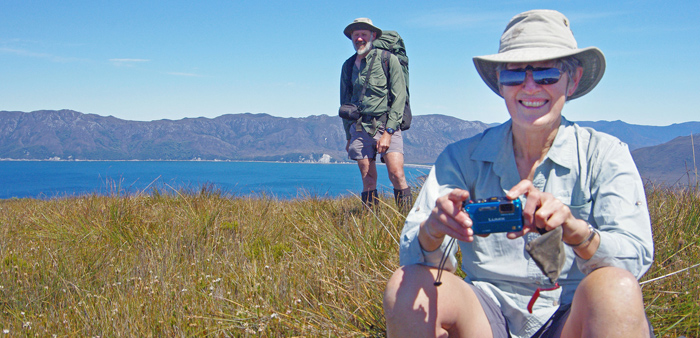 Remote area volunteers can spend up to three weeks tackling weeding out sea spurge along the coastline of Tasmania's Wilderness World Heritage Area.