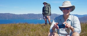 Remote area volunteers, including Andy McQueen and Liz McQueen, can spend up to three weeks tackling weeding out sea spurge along the coastline of Tasmania’s Wilderness World Heritage Area.